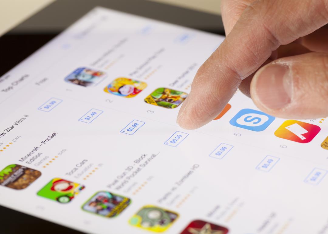 Close-up of a hand scrolling on the App Store on an iPad.