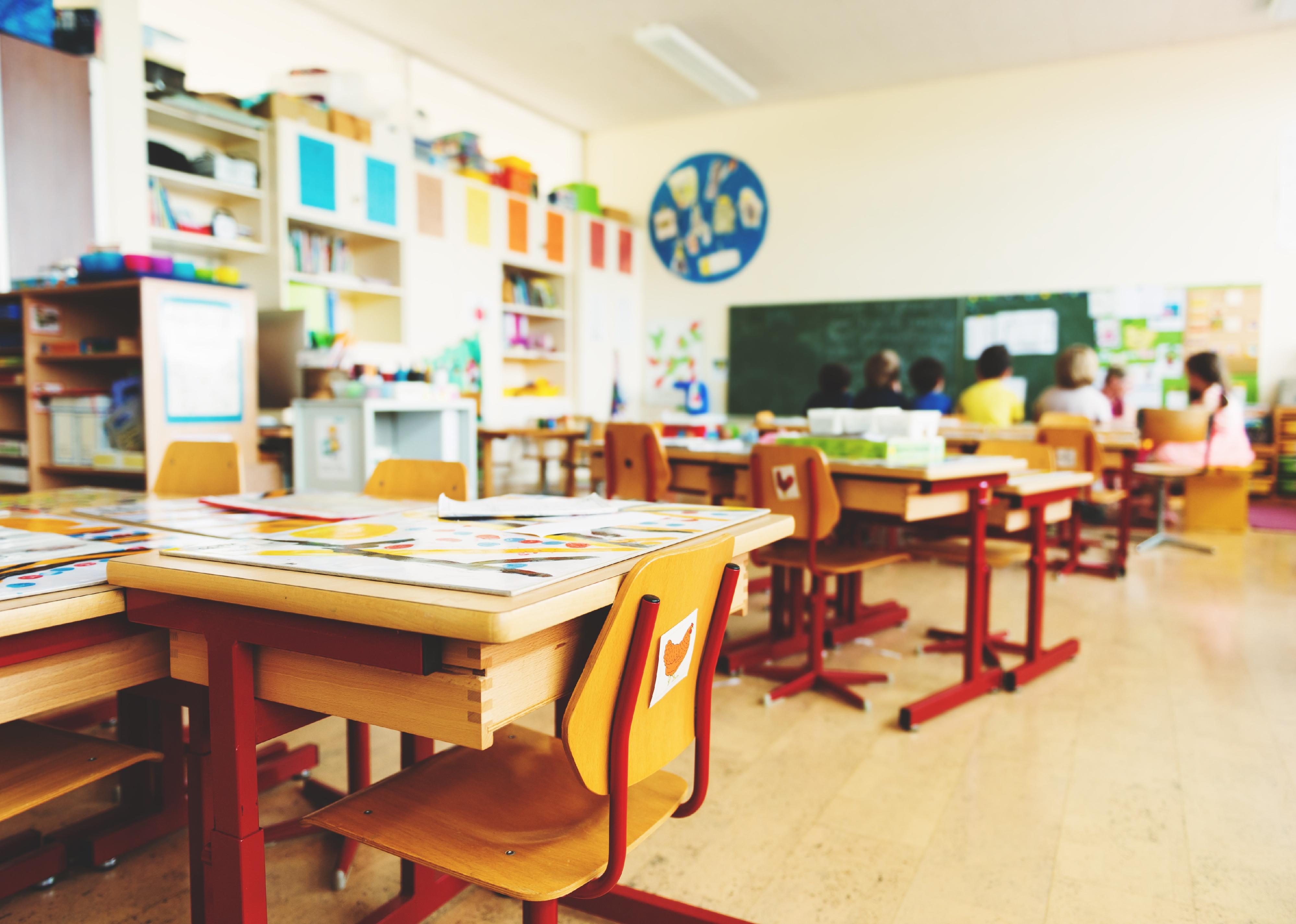 A desk in an empty elementary school classroom