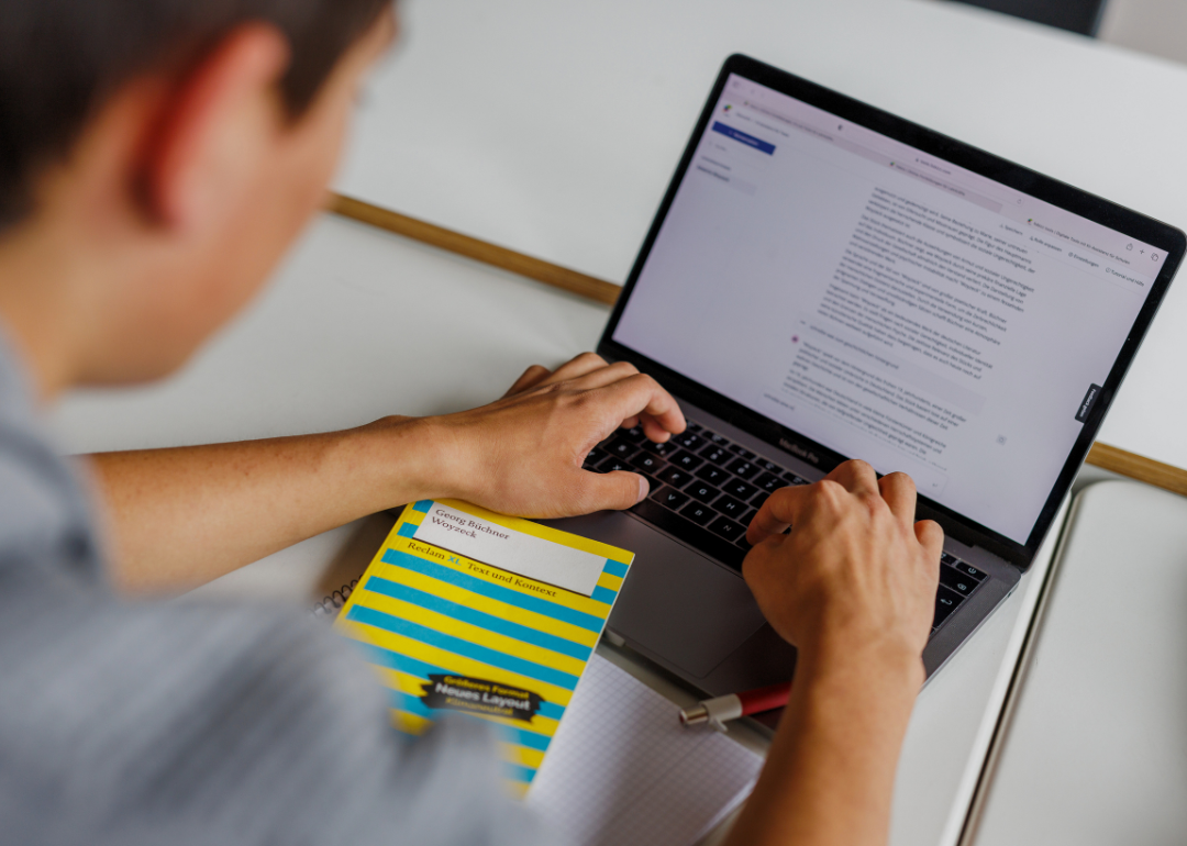 A closeup of student's hands typing on the computer keyboard.