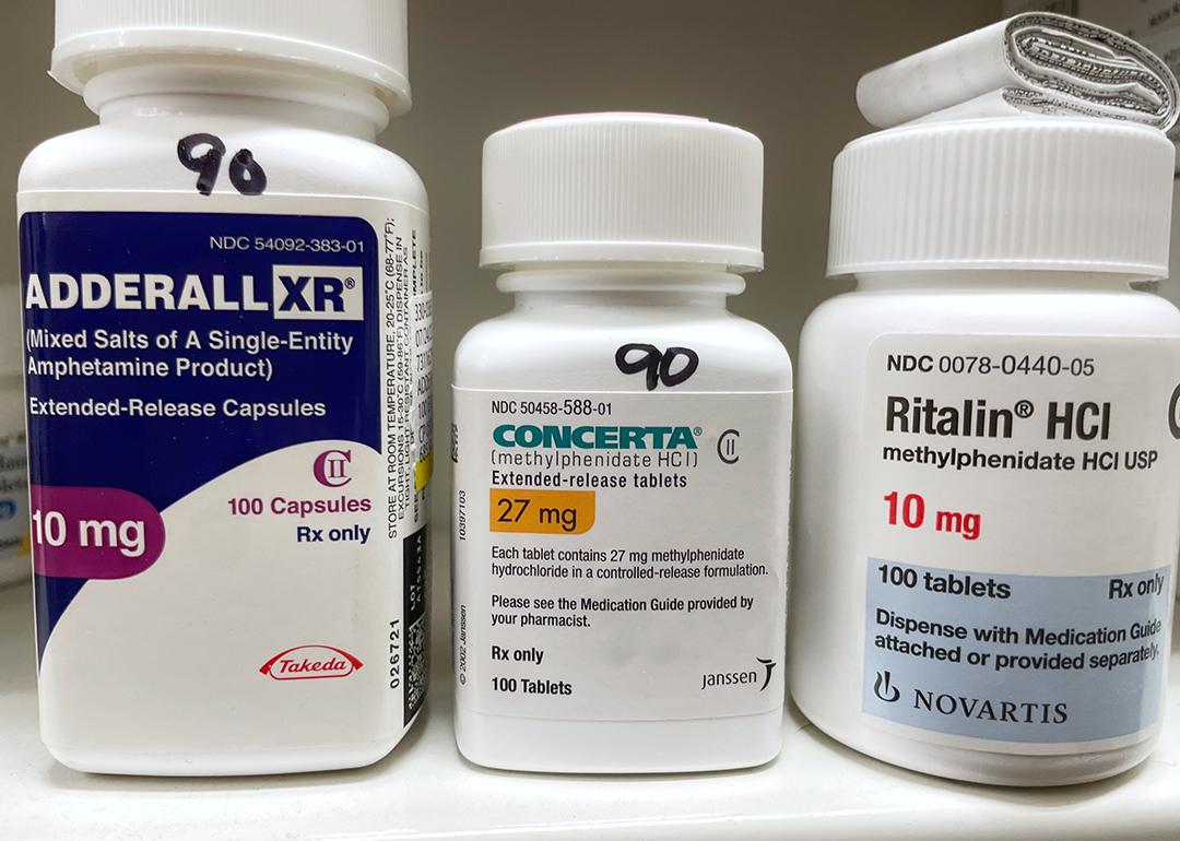 Bottles of ADHD medications such as Adderall, Concerta, and Ritalin.