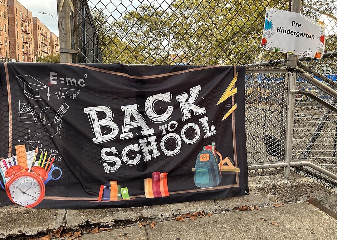 A black "Back to School" banner hangs outside a New York pre-school enrolling a pre-kindergarten class.