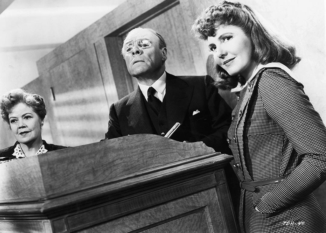 Black and white image of Spring Byington, unidentified man, and Jean Arthur in a scene from the film 'The Devil And Miss Jones', 1941. 