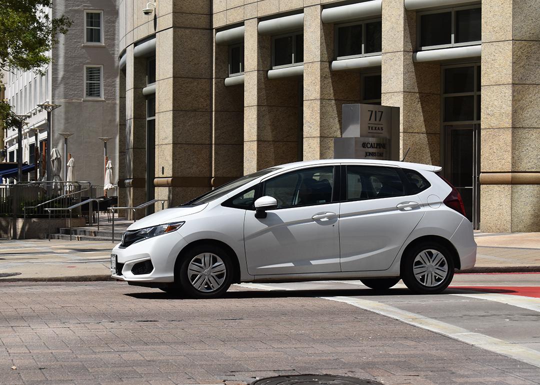 A white Honda Fit EX-L FWD car in downtown Houston, Texas.