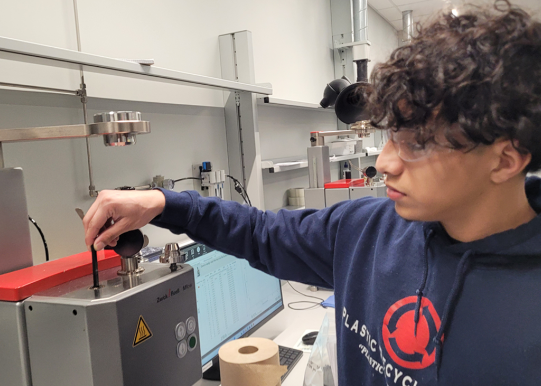 Indianapolis student Danny Bonila works as a lab technician at Plastic Recycling Inc. 