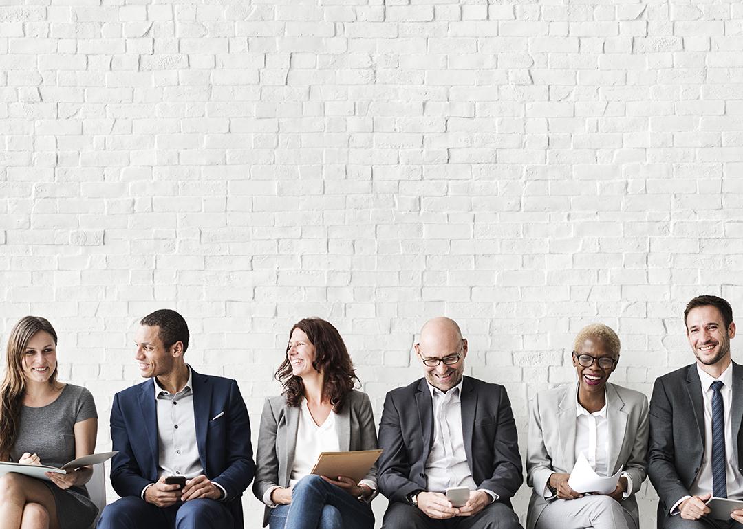 Professionals lined up sitting for a job interview.