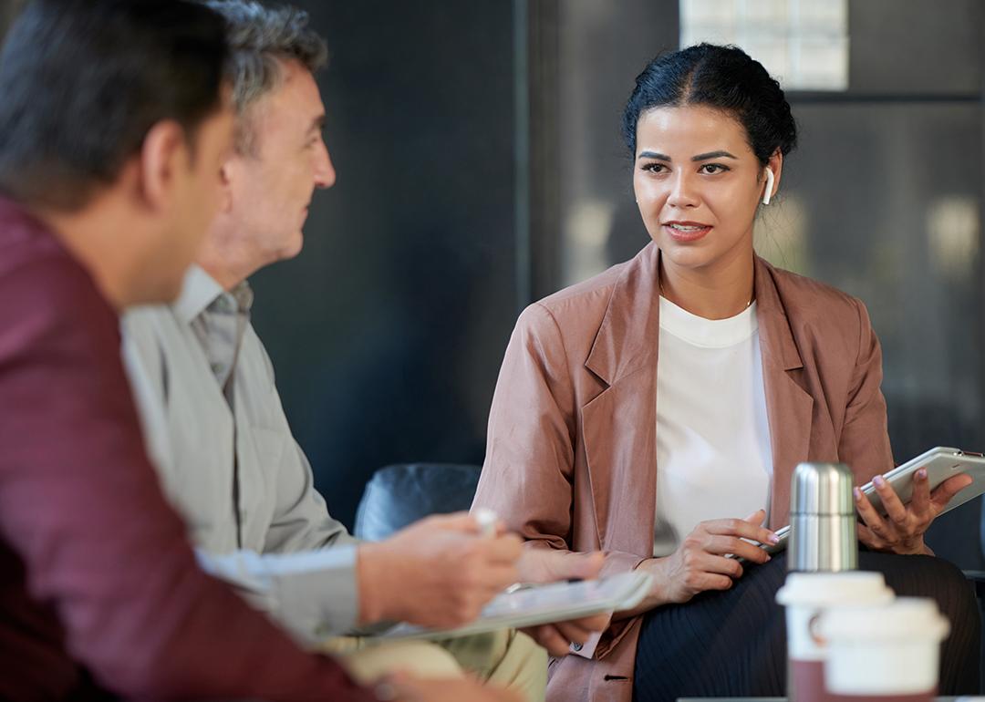 A female chief marketing officer in a meeting with her colleagues.