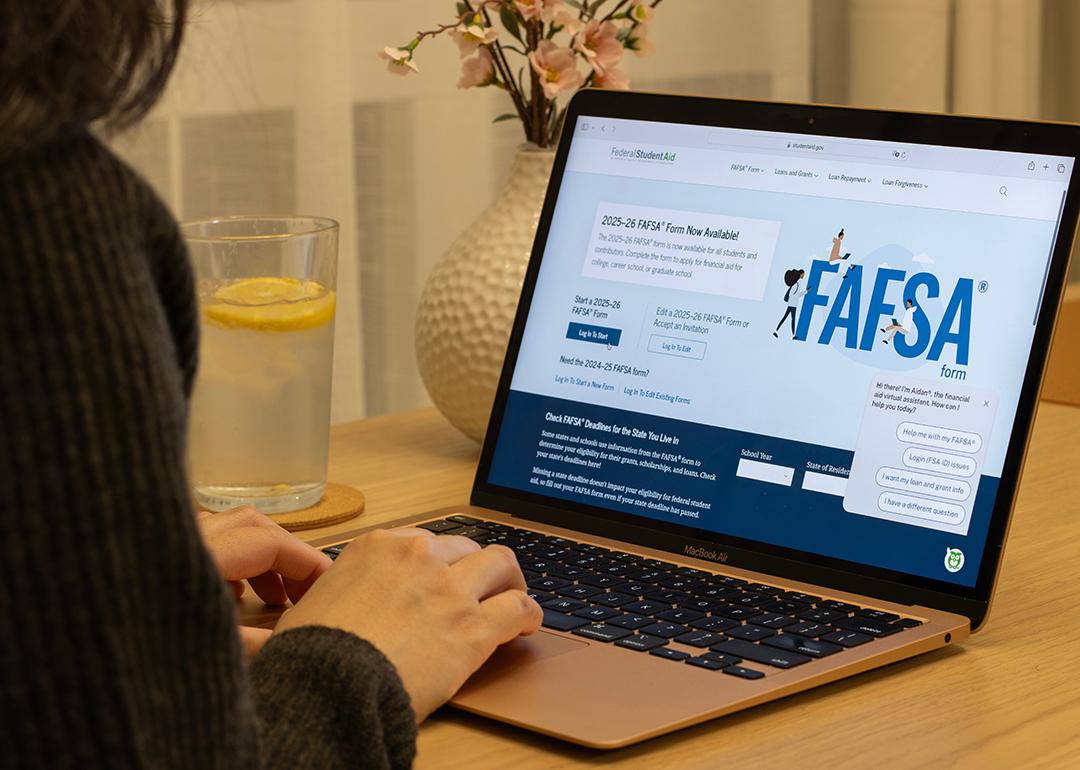 A student browsing the FAFSA website on a laptop.