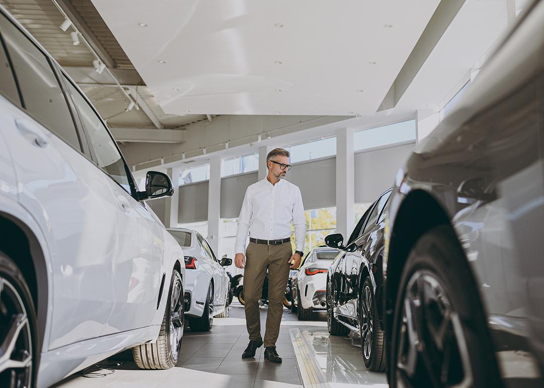 Man looking around a car dealership.