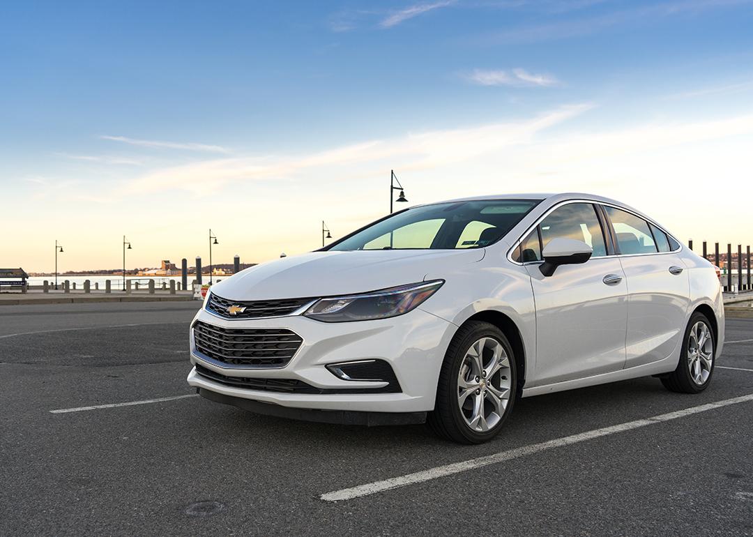 A white 2017 Chevrolet Cruz on a parking lot near seaside.