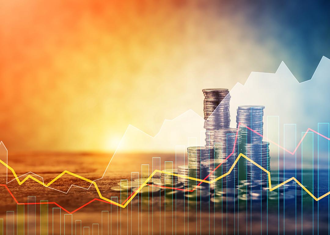 Stacks of coins with an overlay of steady stock trendline graphics.