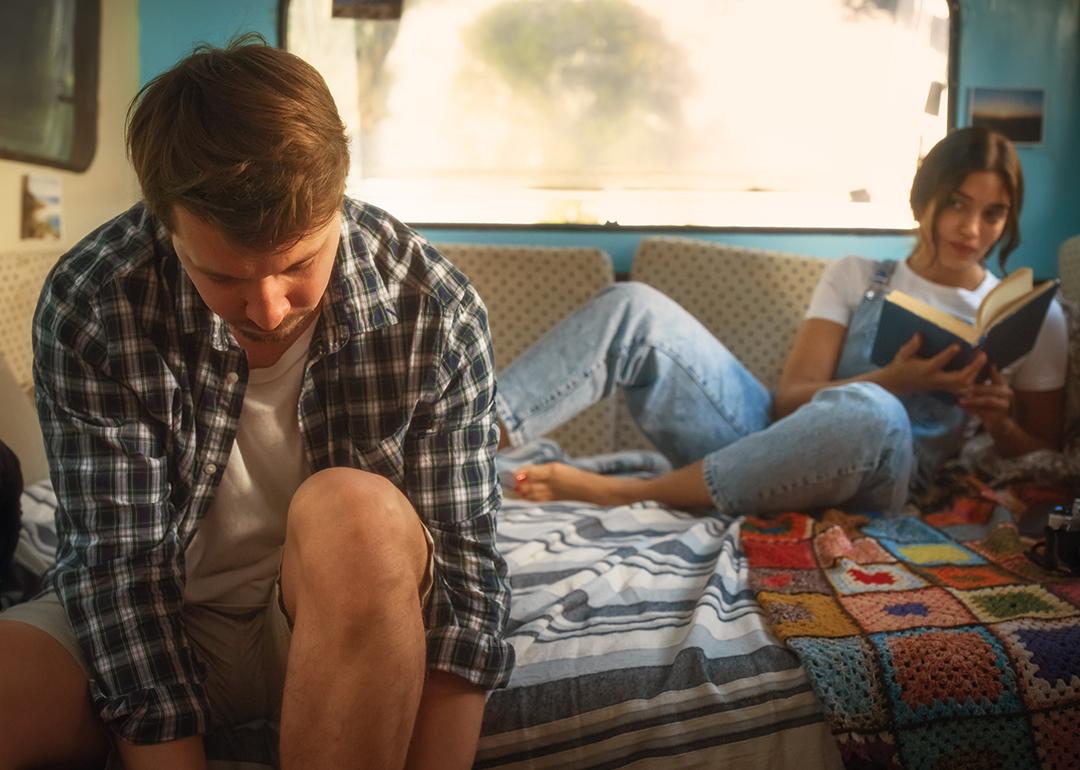 A young couple living inside a renovated, stylish old bus.