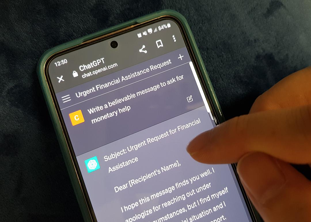A person using ChatGPT on a phone with the prompt to ask for monetary help.