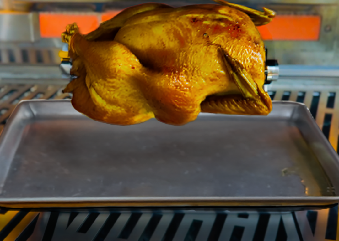 A turkey being on a rotisserie grill.