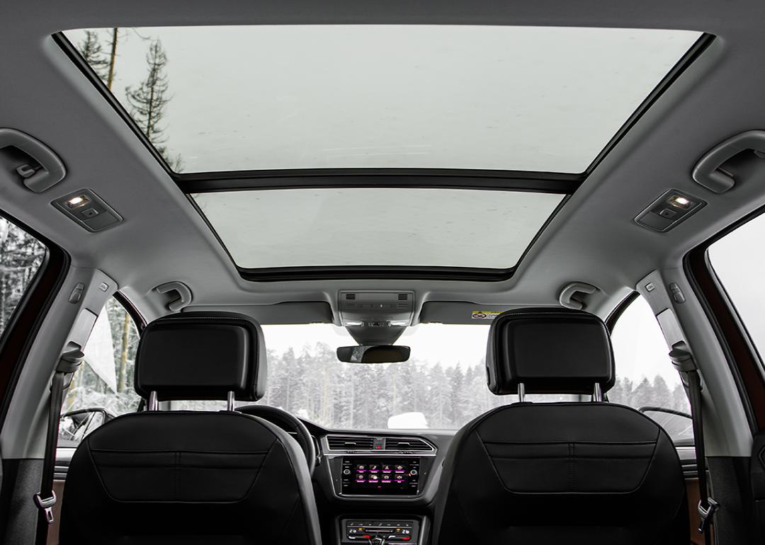 A backseat view of a panoramic roof of a car.