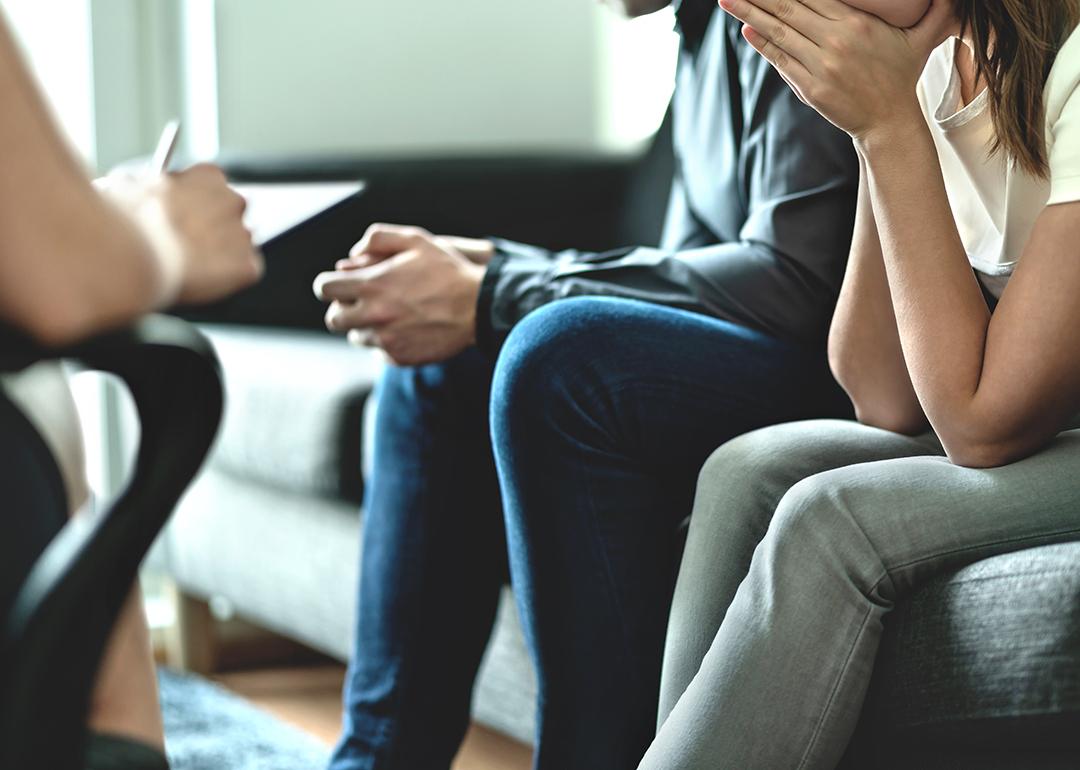 A couple sitting on a sofa during a marriage counseling session.