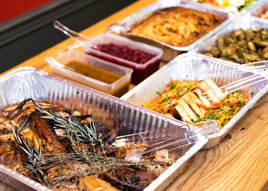 Thanksgiving dishes in catering dishes prepared on the table for serving.