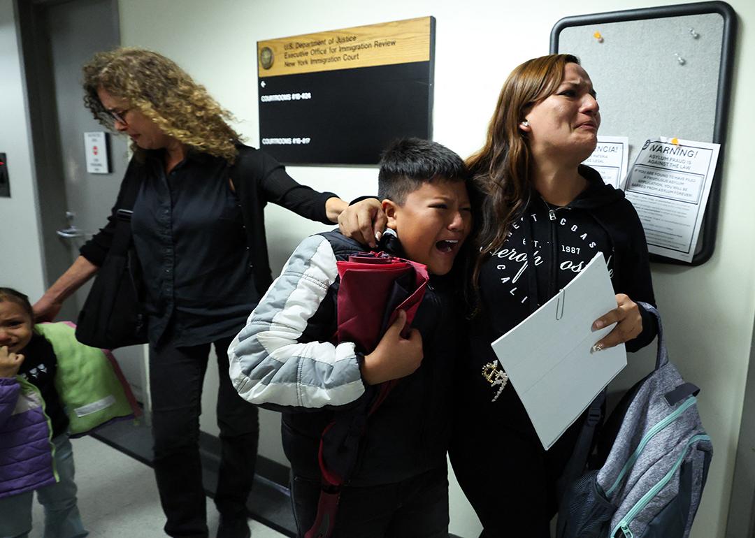 A wife and her children crying as her husband is detained by federal agents outside a New York Federal Plaza Immigration Court room in New York City.