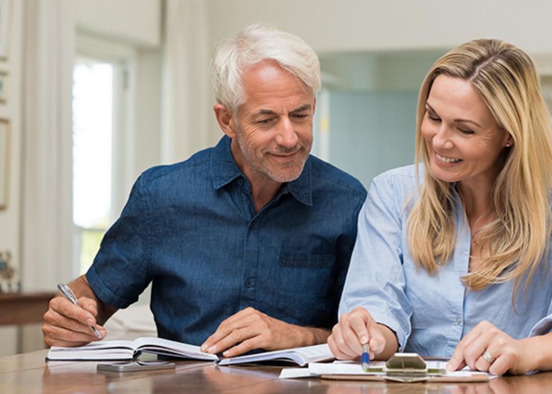 A man and a woman looking at financial documents.