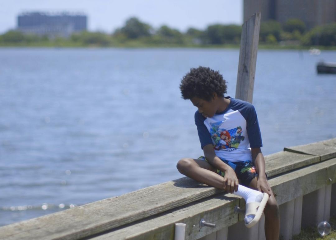 A boy looking out over Jamaica Bay in the Edgemere neighborhood of New York City.