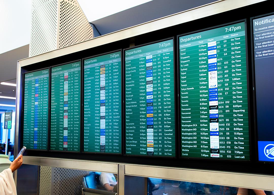 A flight arrival and departure board at an airport.
