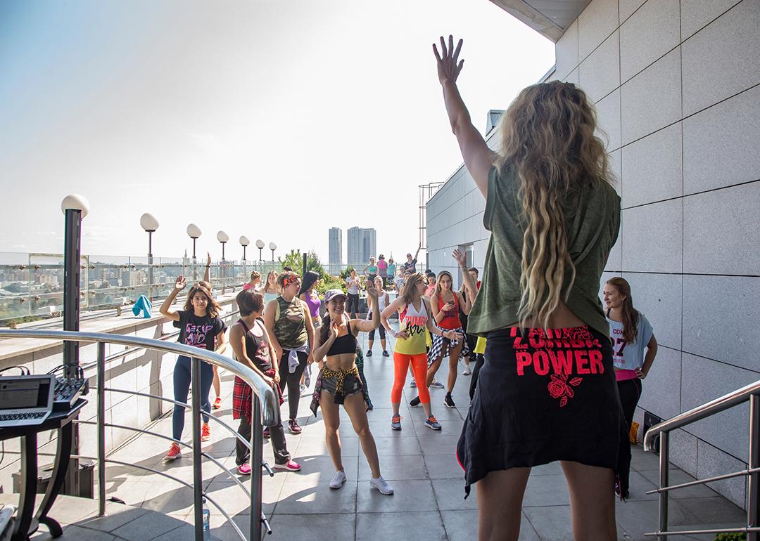 A group having a Zumba party at the top floor of a hotel.