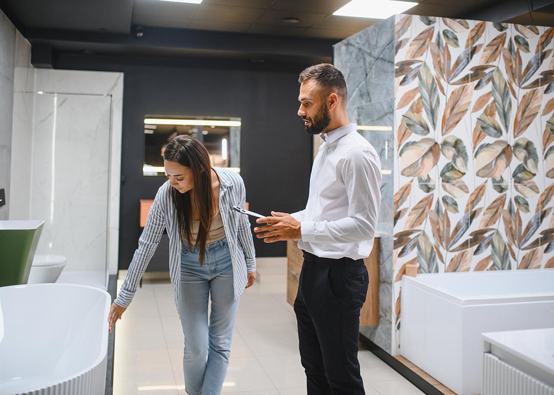 A young couple choosing new bathroom furniture.