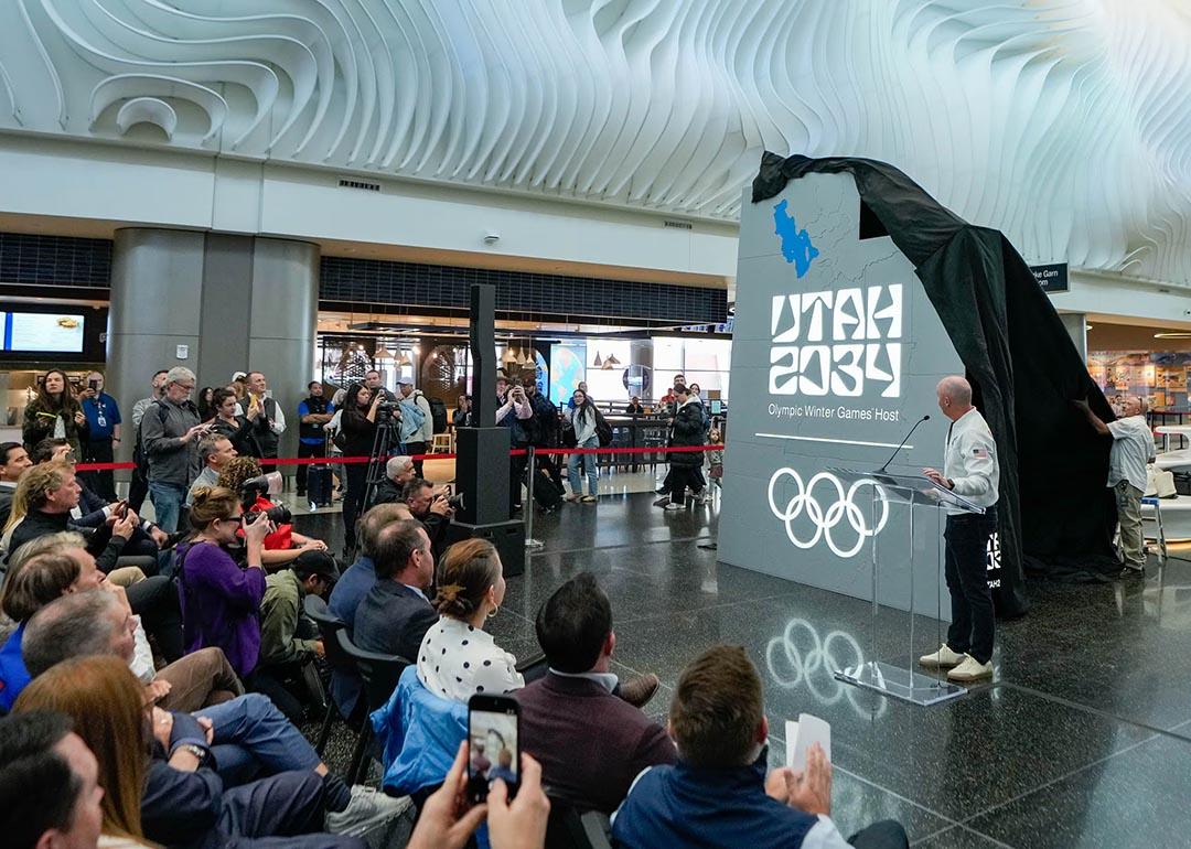 A crowd watches as organizers reveal a new name and logo — Utah 2034 — at Salt Lake City International Airport, as they count down les than 3,000 days until the Olympic Winter Games return to Utah.    