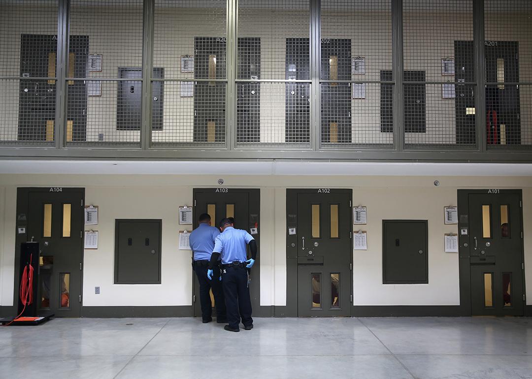 Guards prepare to escort an immigrant detainee from his 'segregation cell' back into the general population at the Adelanto Detention Facility on November 15, 2013 in Adelanto, California.