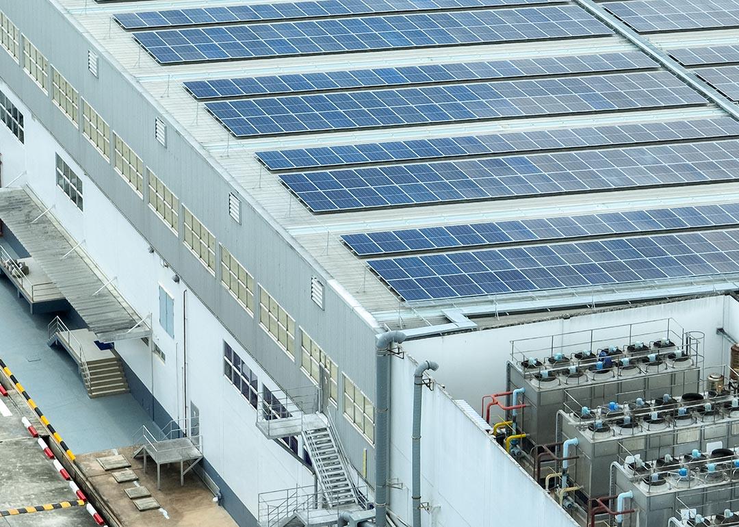 A warehouse building with solar panels on the rooftop.