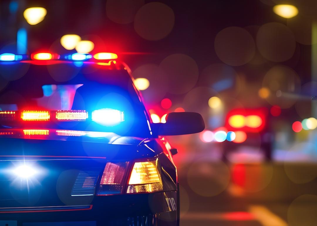 Police car at night in an urban environment.