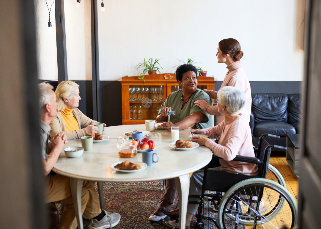 A group of older people at a table having breakfast.