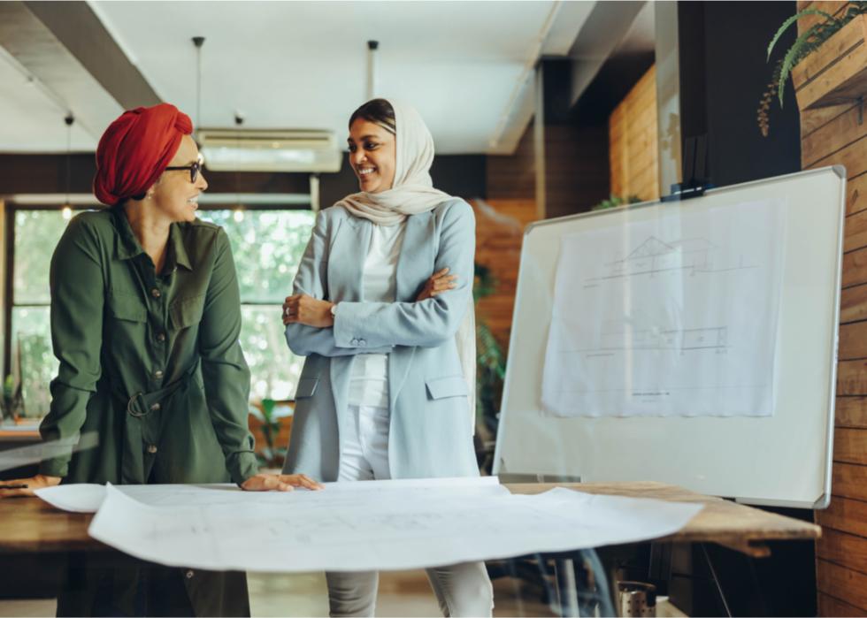 Two multicultural colleagues discuss project