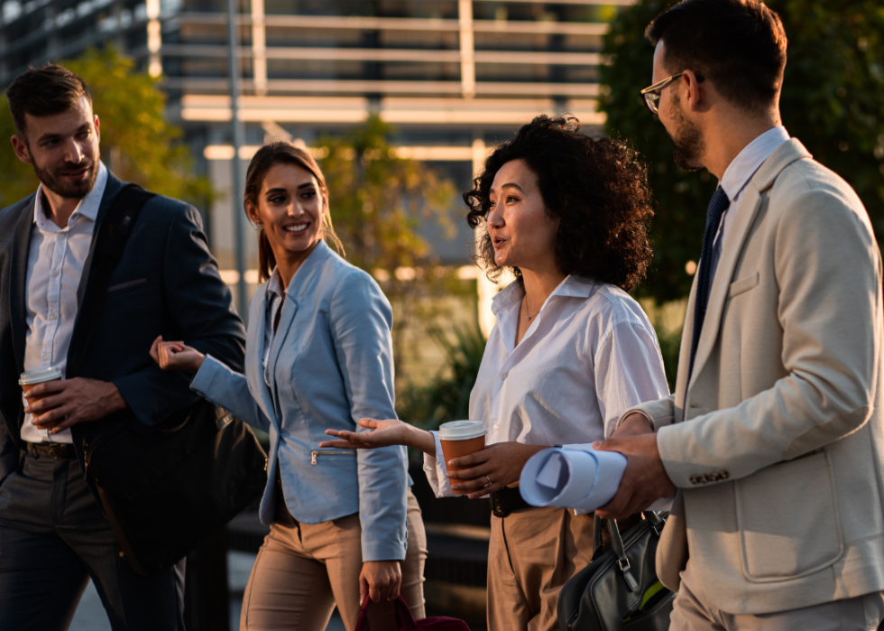Diverse group of business people walking in sun