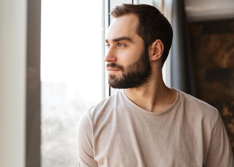 Man looking out window.