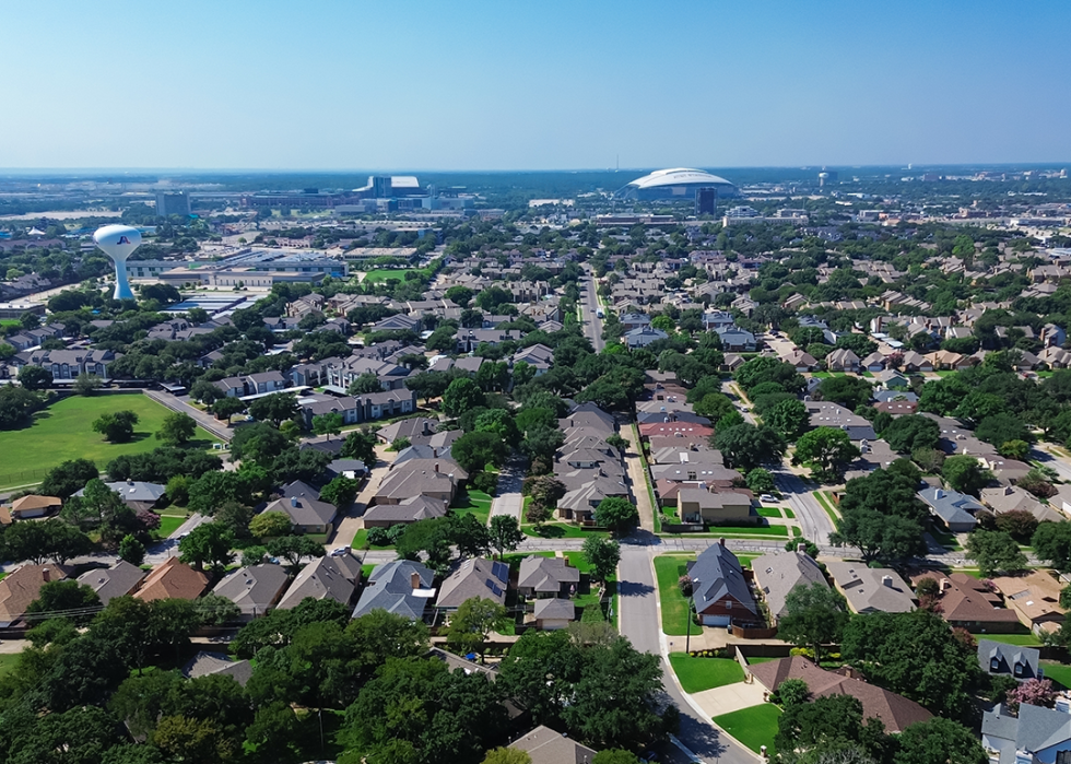 Single-family houses,water tower and ATT Stadium in Arlington.