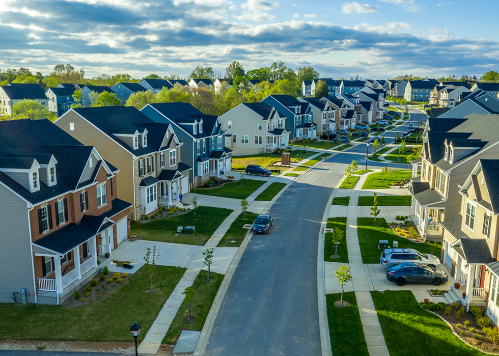 Aerial view of classic upper middle class neighborhood street with luxury single family homes.