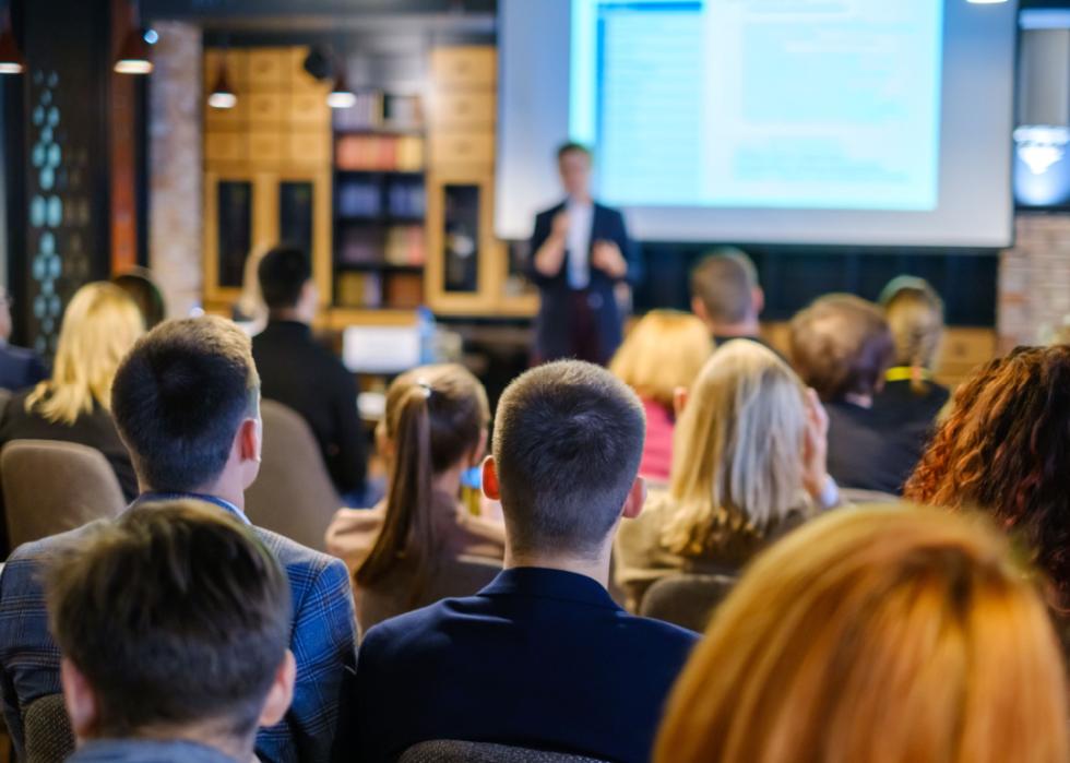 Professionals attend workshop with speaker.