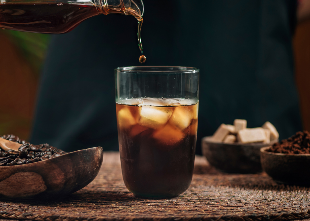 Iced coffee drink being poured.