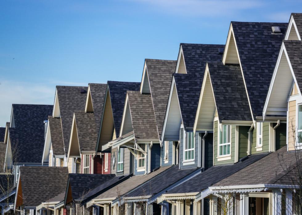 Row of homes with blue sky.