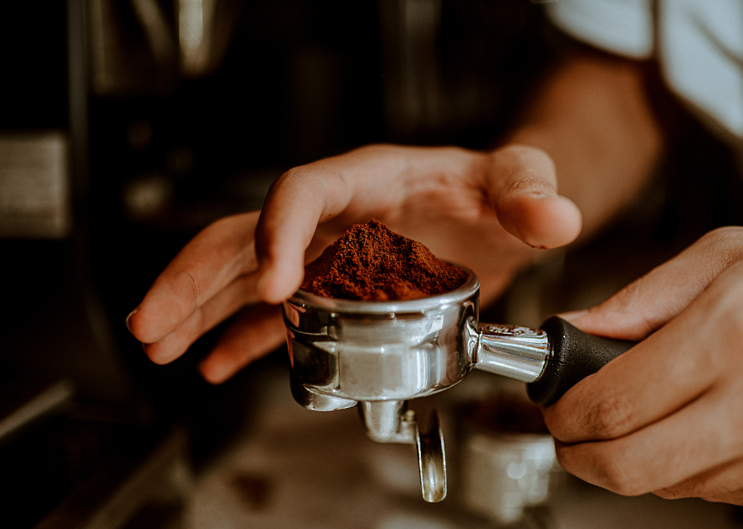 Barista preparing ground espresso.