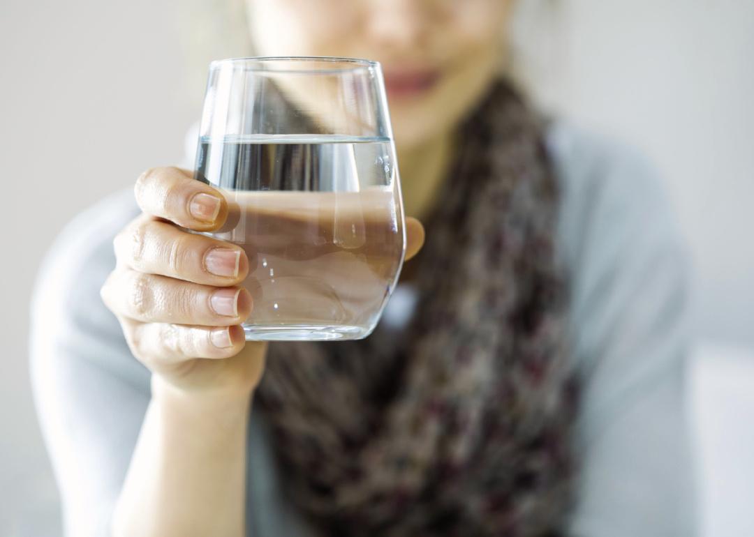 Woman holding glass of water