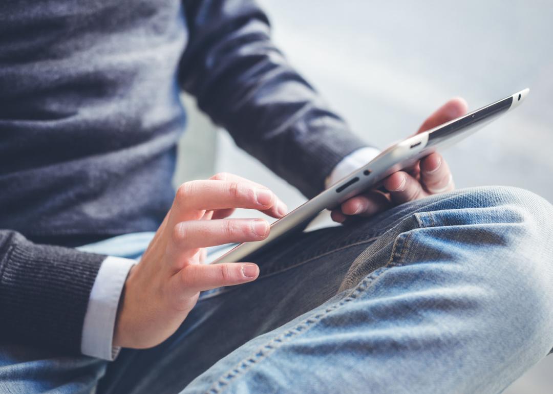 Close up hands holding tablet.