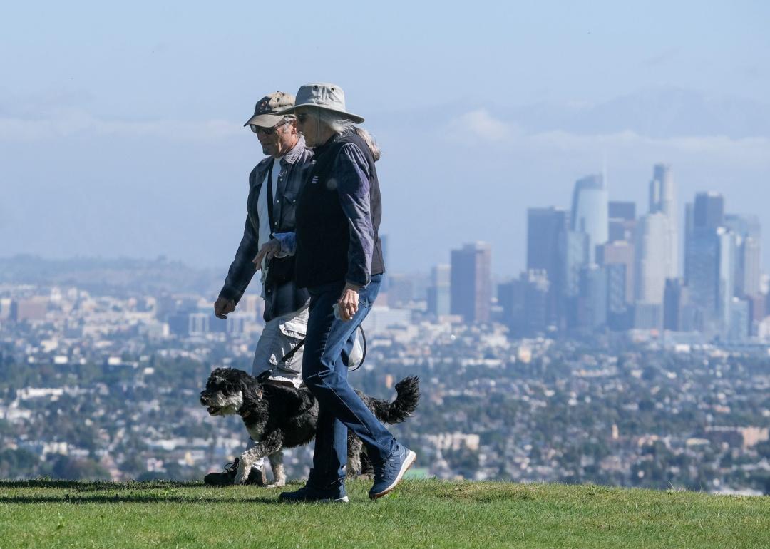 People walking dog in Kenneth Han Park.