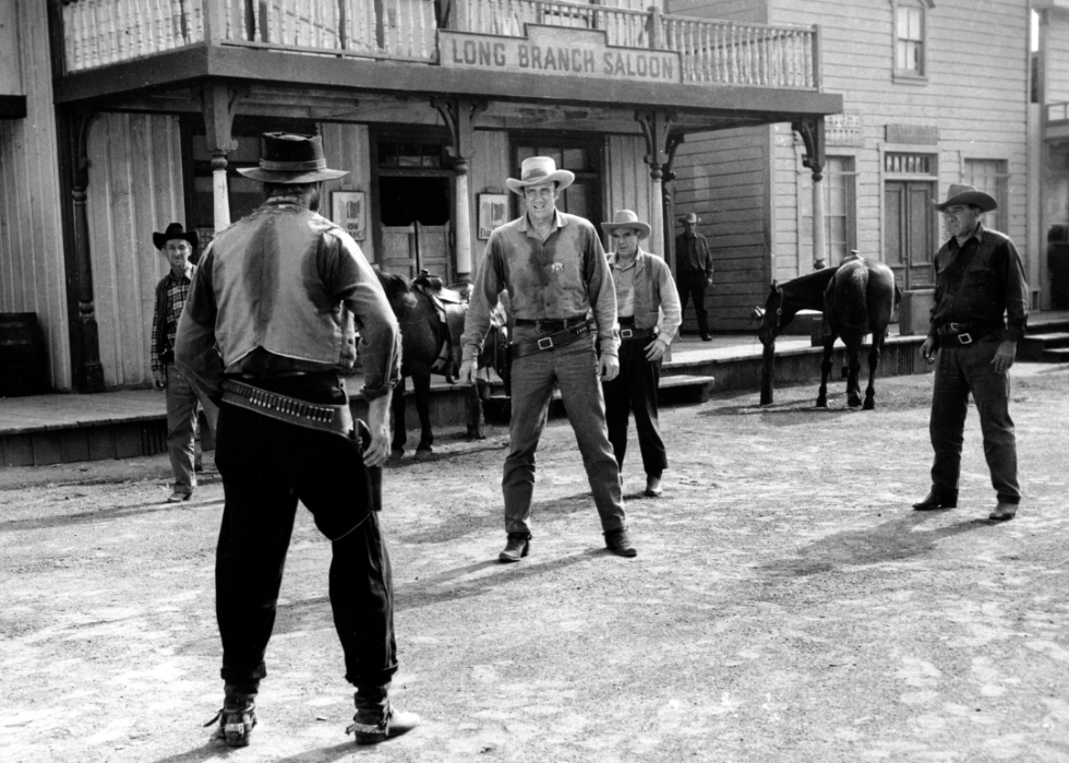 Cowboys having a duel in the street.