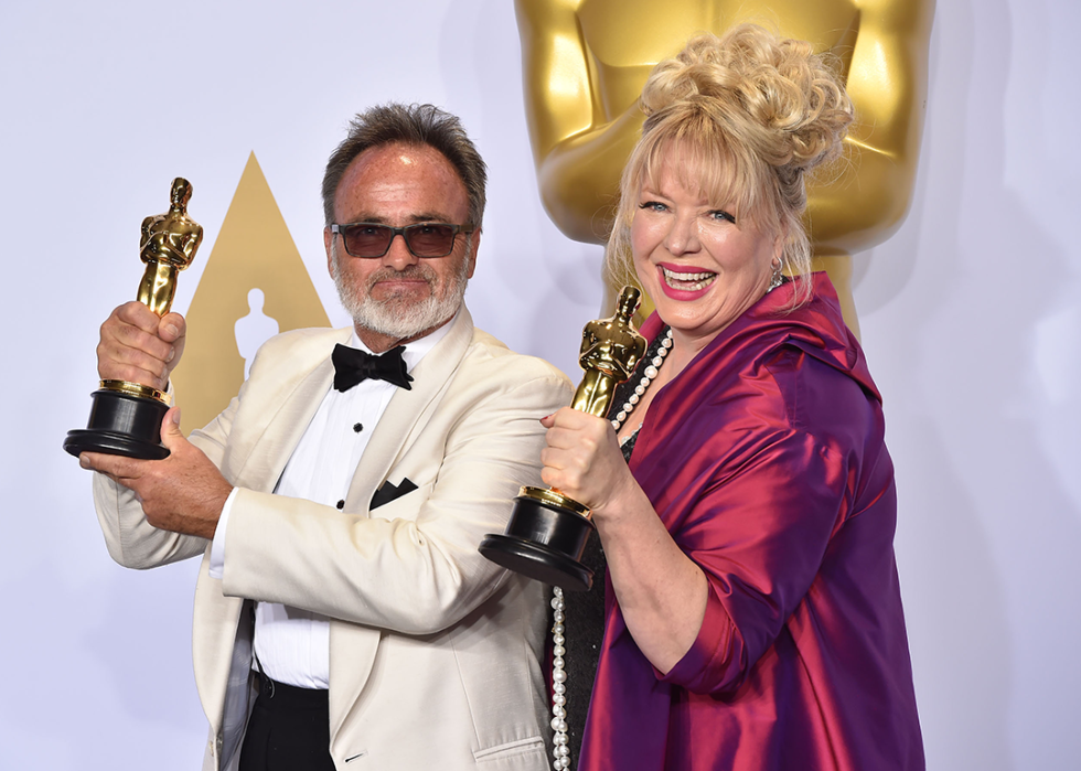 Colin Gibson and Lisa Thompson pose with their award for Best Production Design.