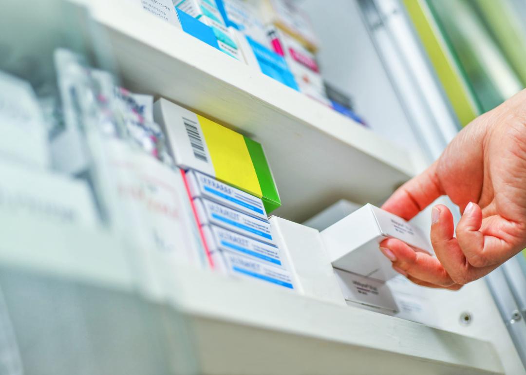Pharmacist holding medication box.