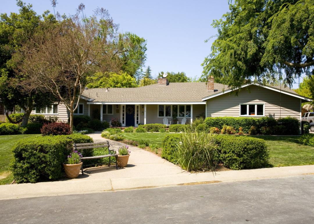 Exterior of yellow ranch house.