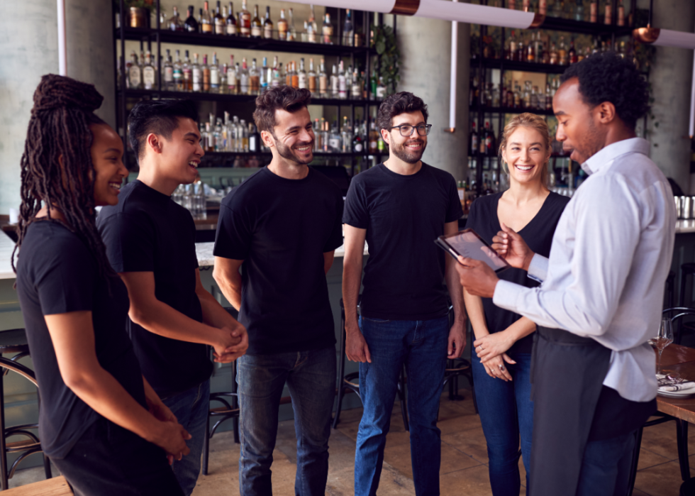 Restaurant manager talking to team.