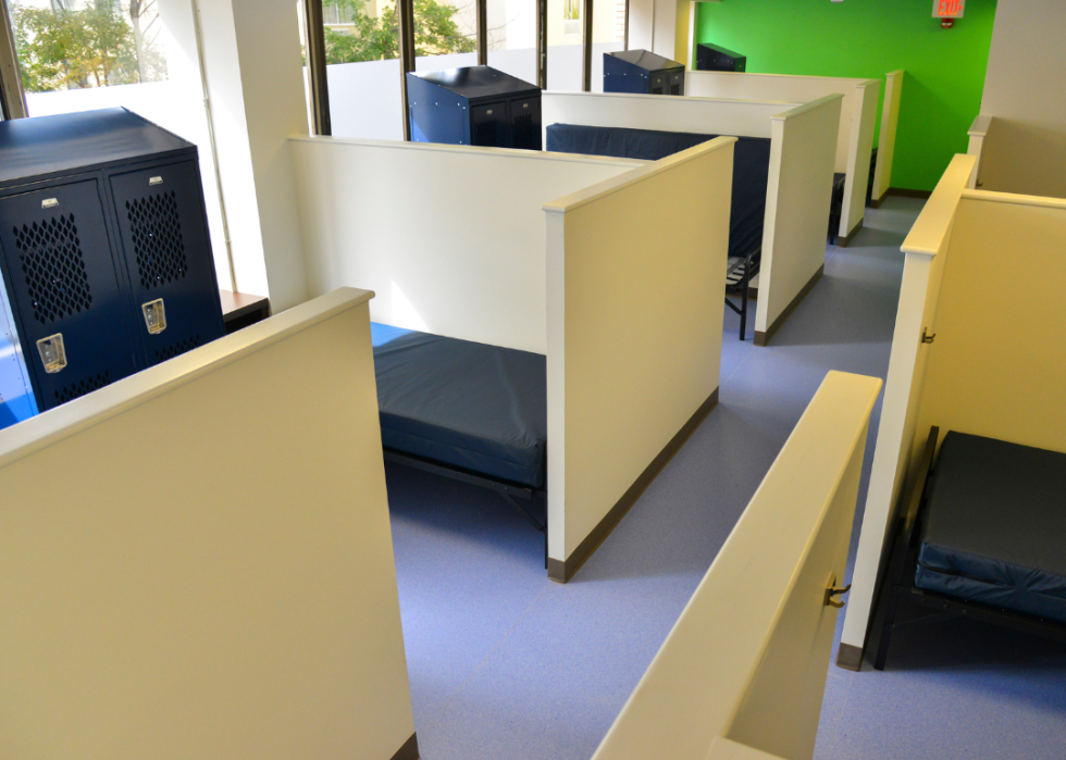 View of cubicles in sleeping area of a temporary shelter.