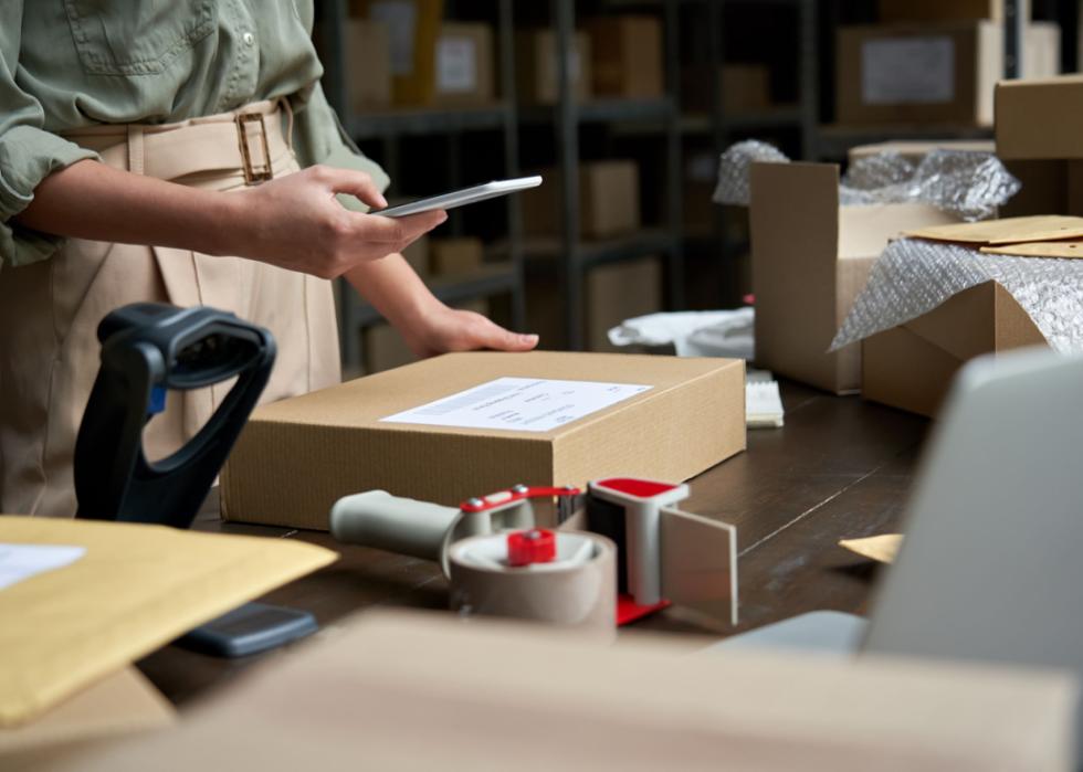 Person preparing package for shipping.